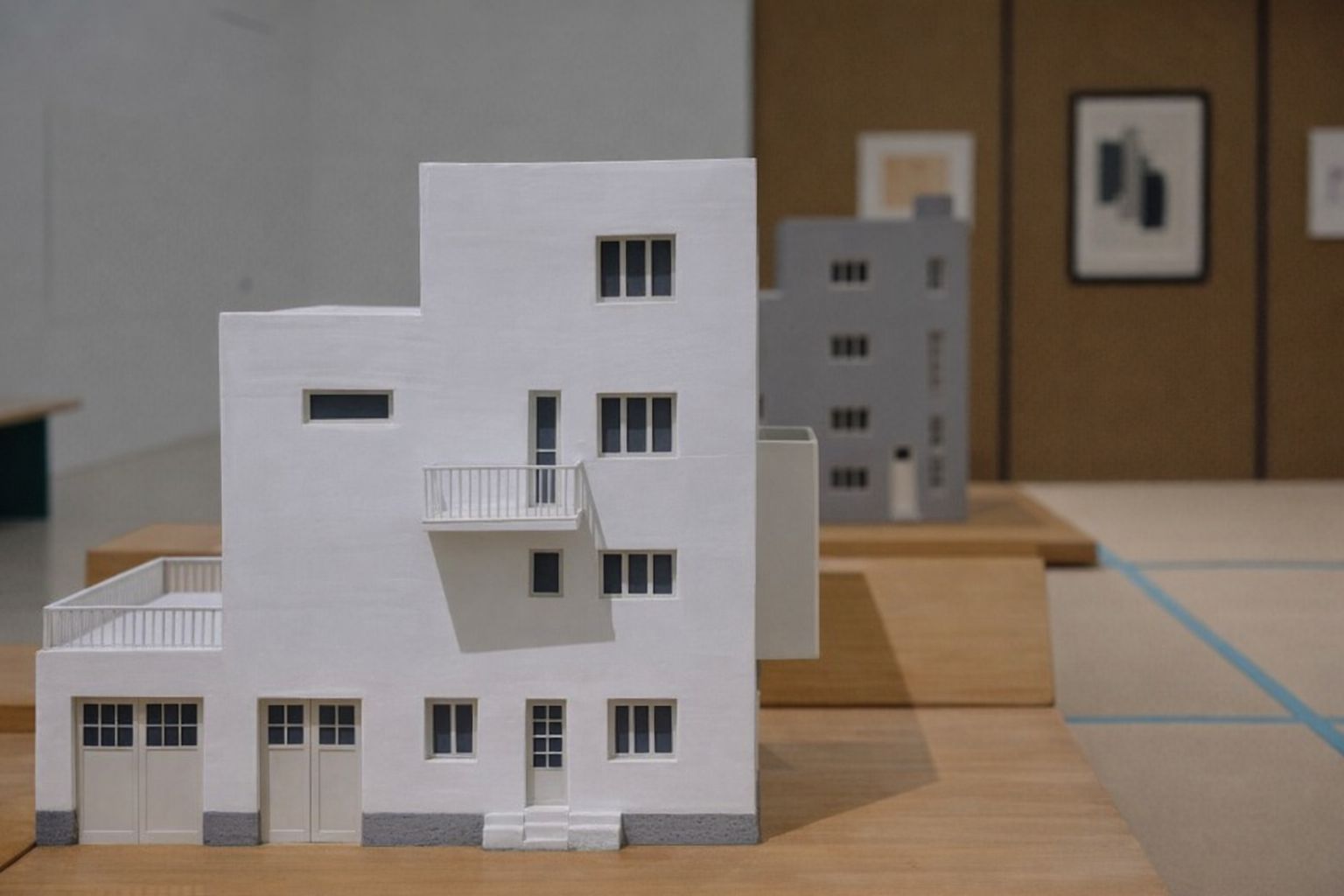 Weißes Architekturmodell eines modernen Hauses in einer Ausstellung.